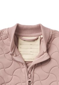 Light pink quilted jacket with ribbed collar and zip closure. Features textured wave patterns and a tag with care instructions inside.