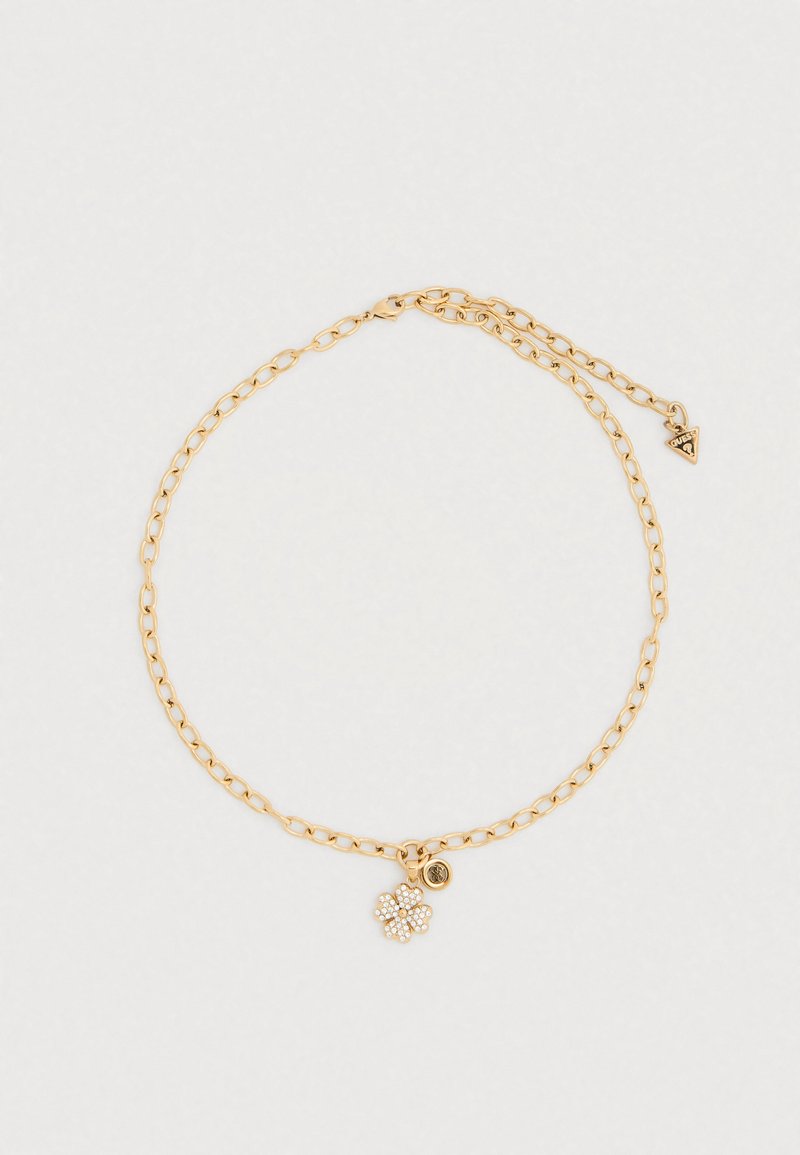 Χρυσό κολιέ αλυσίδας με μενταγιόν σε σχήμα λουλουδιού διακοσμημένο με μικρούς κρυστάλλους και διακοσμητική πλακέτα στο κούμπωμα.