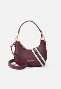 Burgundy leather handbag with a curved shape, gold hardware, and a detachable shoulder strap featuring "Valentino" in bold, contrasting letters.
