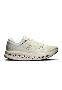 Chaussure de sport beige clair avec une tige en mesh, des détails réfléchissants et une semelle au design unique présentant des découpes ovales pour l'amorti.