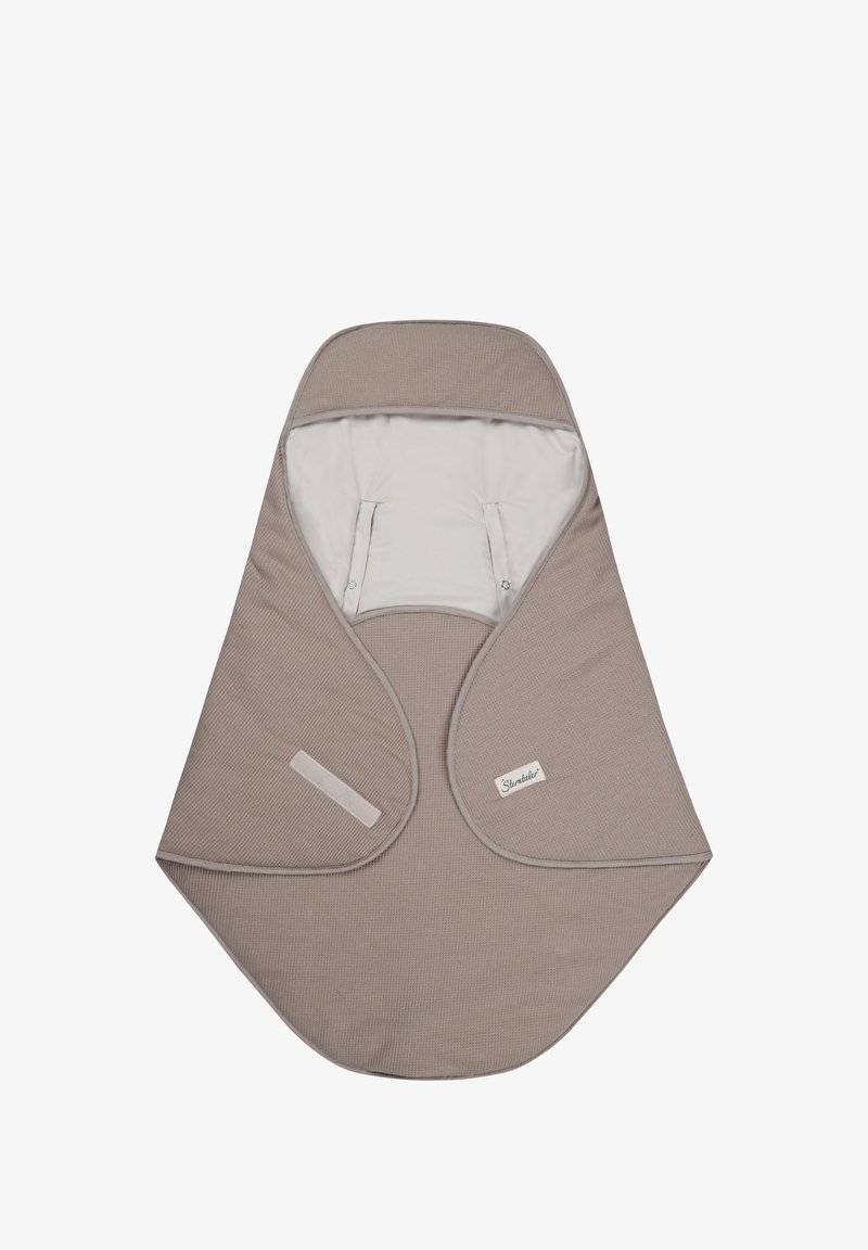 Beige baby wrap with a textured surface, rounded shape, and a soft inner lining. Features snap closures and a fabric label.