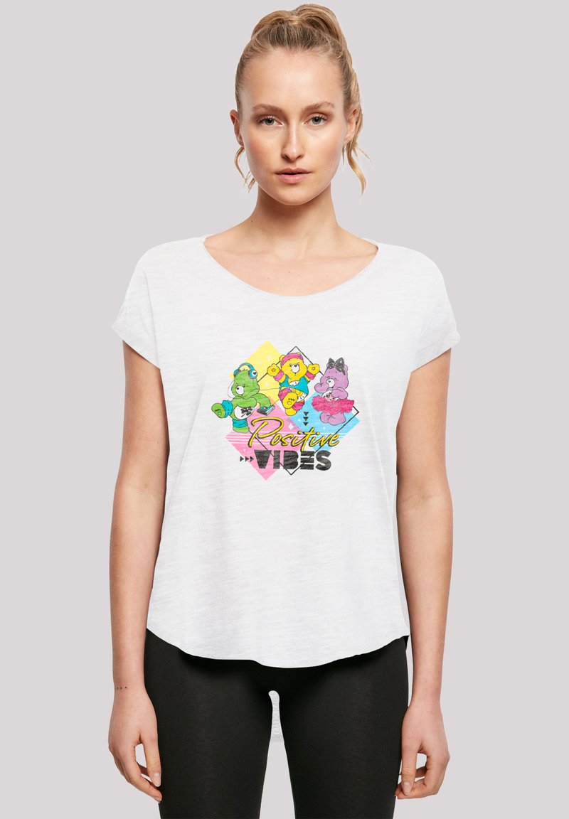 White short-sleeve t-shirt featuring cartoon bears in green, yellow, and pink with "Positive Vibes" text in various colors on the front.