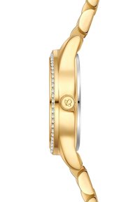 Kuldtooni kell, millel on sile, ümar korpus, aktsentideks on selge kristallide rida serva mööda ja metallist rihm kõverate linkidega.