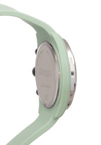 Mintgrön klocka med baksida i rostfritt stål, runt silverfärgat hölje och slät silikonrem. Har sido-knappar för justeringar.