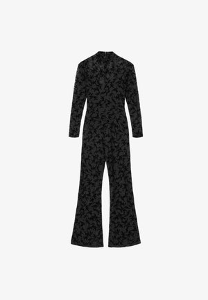 Macacão preto com padrão floral, mangas compridas, gola alta e pernas largas. Feito de tecido texturizado.