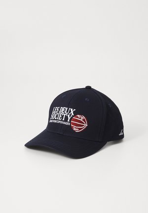 Navy blue baseball cap with embroidered “LES DEUX SOCIETY” logo and basketball graphic. Features a curved brim and adjustable back.