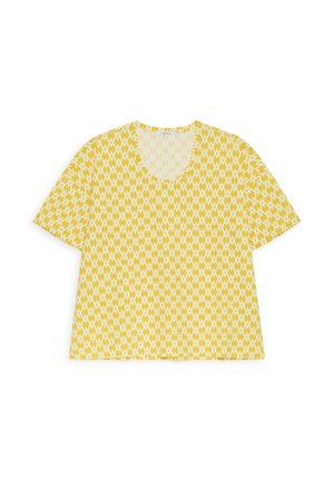 T-shirt gialla con motivo geometrico bianco a forma di diamante, maniche corte e scollo rotondo, mostrata su sfondo bianco.
