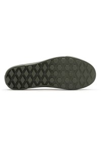 Green rubber shoe sole featuring a textured hexagonal pattern and raised accents; flat design with rounded edges for grip and stability.