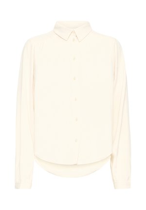 Krems krāsas garām piedurknēm kreklis ar apkakli, pogām priekšā un izliekumu apakšējā daļā. Izgatavots no mīksta, gluda auduma ar ieliktu tekstūru.