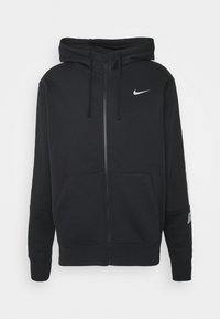 Svart zip-up hoodie tillverkad av en blandning av bomull. Funktioner en framficka, dragsko-kapuschong och en liten silverfärgad Nike-logotyp på bröstet.