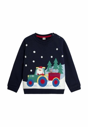 Tumši zila džemperis ar krāsainu traktoru, kurā ir Ziemassvētku vecītis un laulātais, uz priekšpuses izrotāts ar sniegpārsliņām un zaļiem kokiem.