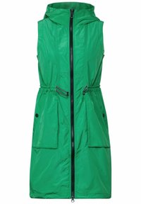 Giacca verde senza maniche con cappuccio, dotata di una cerniera frontale, vita regolabile con cordino elasticizzato e due grandi tasche frontali. Materiale morbido e leggero.