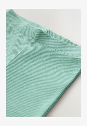 Mintrohelise rohelise soonilise kangaga, millel on pehme tekstuur, ühtlane vöökoht ja siledad õmblused. Ese on voltitud, et näidata ülemist serva.