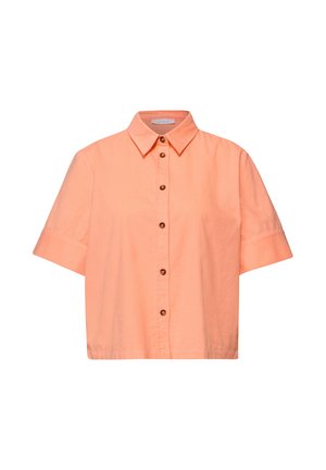 Short-sleeve, button-up peach shirt with a pointed collar and six brown buttons down the front.