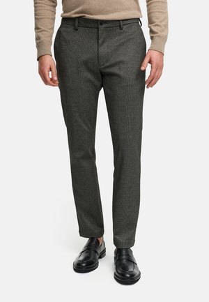 Gray checkered dress pants with a fitted design, made from textured fabric, paired with black slip-on shoes.