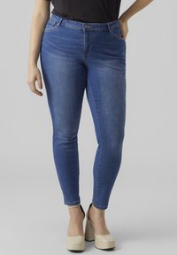 Blue denim skinny jeans with a mid-rise waist and a classic five-pocket design. Smooth texture, subtle fading, and seam detailing.