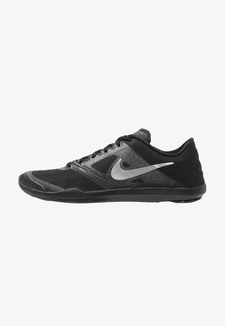 Musta urheilukenkä, jossa on teksturoitu verkkomateriaali päällä, hopeinen Nike-tikkusymboli, tasapohja ja minimaalinen nauhakuosi. Kevyt rakenne.