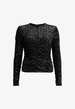 Svart långärmad topp i texturerad tyg med ett subtilt leopardmönster, med samlad detaljering längs sidorna och ärmarna.