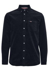 Svart kordfløyelskjorte med lange ermer, krage med knapper, frontlomme og hvite knapper. Har fargede detaljer på lommen.