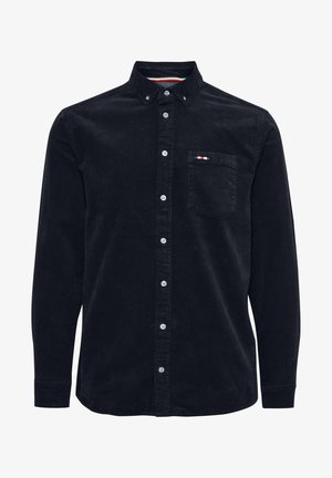 Čierna kordúrová košeľa s dlhými rukávmi, s golierom na gombíky, prednou vreckom a bielymi gombíkmi. Obsahuje farebné akcenty na vrecku.