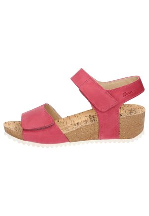 Sandalo a zeppa in pelle rosa con plantare in sughero, cinturini regolabili in Velcro e suola in gomma bianca testurizzata. Superficie liscia con dettagli minimi.