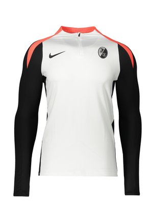 Langærmet sportstrøje med hvid front, sorte ærmer, røde skulderdetaljer, Nike-logo og holdslogo på brystet.