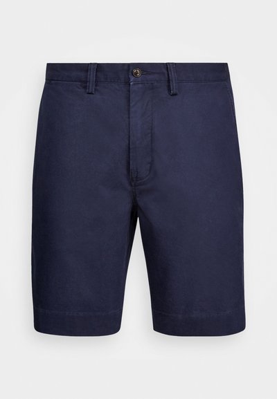 Σκούρο μπλε βαμβακερές σορτς με κούμπωμα, μπροστινές τσέπες και διακριτή υφή. Απολήγουν στο γόνατο με καθαρή τελείωση.