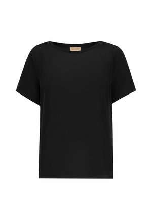 Blouse noire à manches courtes, coupe ample, col rond large et ourlet droit.