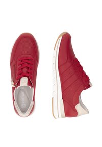 Red leather sneakers with perforated design, white sole, lace-up front, and zipper detail on the side. Beige accent on heel.