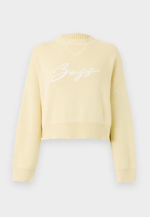 Geltona trumpa sweatshirt su suglebusiomis apykaklėmis ir rankogaliais. Puikuojasi balta užrašyta "Boss" logotipu per krūtinę. Visame audinyje matomas megztas raštas.