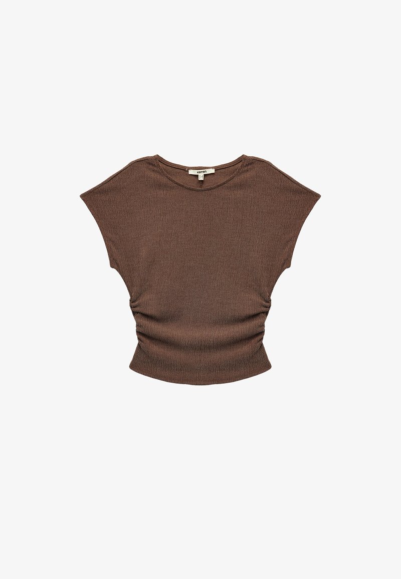 Brown, short-sleeve top with a relaxed fit, featuring a textured fabric and gathered detail at the waist. Smooth neckline and soft texture.