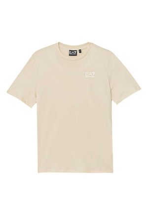 T-shirt beige a maniche corte con scollo tondo e logo bianco EA7 Emporio Armani sul lato sinistro del petto e etichetta nera sul collo.
