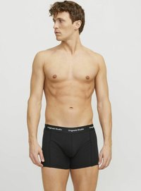 Schwarze Boxershorts für Männer mit einer enganliegenden Passform, ausgestattet mit einem elastischen Bund, der mit "Originals Studio" beschriftet ist. Glattes Material und minimale Nähte.