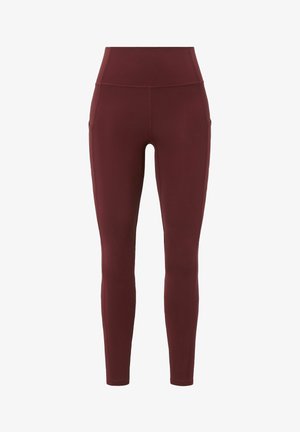 Burgunderfarbene Leggings aus elastischem Stoff. Hoher Bund mit Seitentaschen. Glatte Textur und knöchellanges Design. Keine sichtbaren Muster.