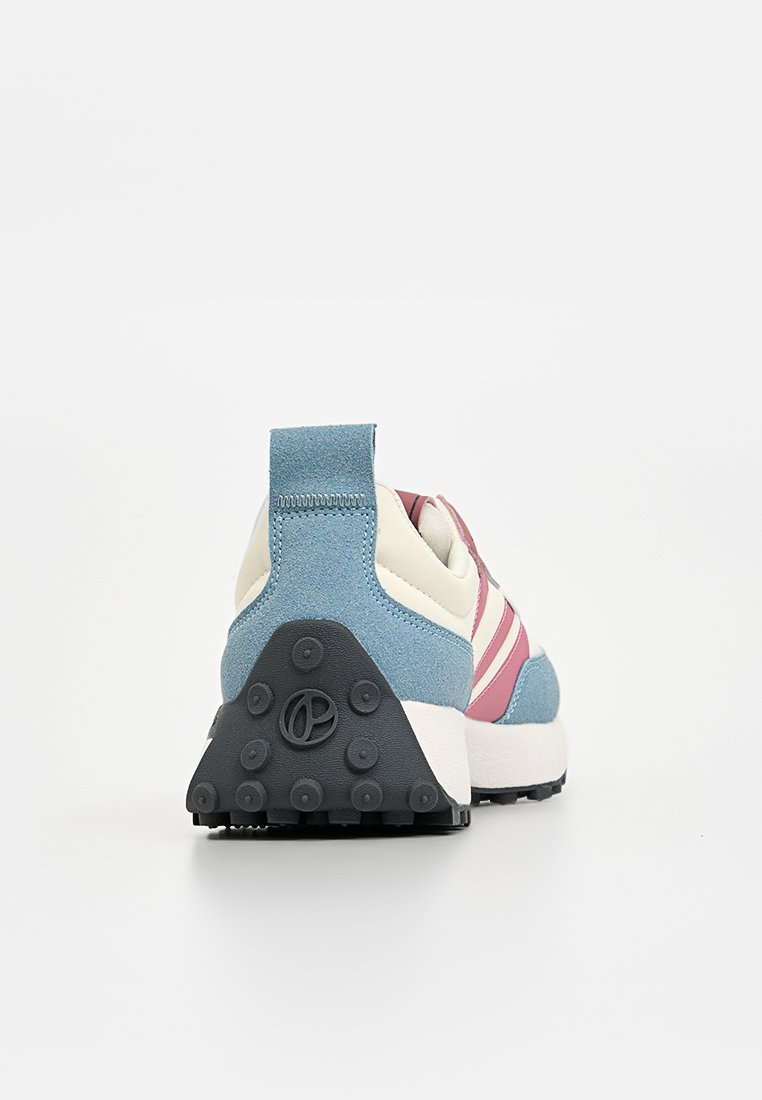 Zapatilla con parte superior de ante azul, rayas blancas y rosas, tacón redondeado y suela negra texturizada con almohadillas de tracción circular.