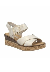 Gold-tone wedge sandal with cross straps in metallic beige. Features a cork-like textured sole and adjustable ankle strap with buckle.