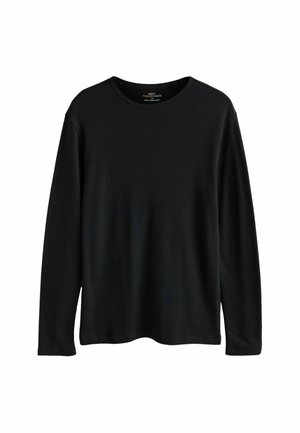 Črna majica z dolgimi rokavi in okroglim izrezom. Izdelana iz rebraste pletenine, ima sproščen kroj brez vidnih vzorcev ali poudarkov.