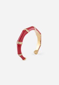 Rotes Armband mit glatter Oberfläche, das goldene Akzente und klare Steine in regelmäßigen Abständen aufweist und ein Bambusdesign imitiert.