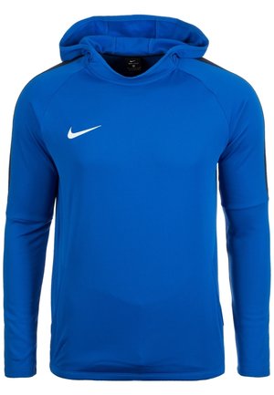 Niebieska długa bluza z kapturem Nike z czarnymi paskami na ramionach i białym logo Nike swoosh na piersi, pokazana na białym tle.