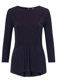 Mörkblå långärmad topp med texturerat prickmönster på övre panelen, lätt material, rund halsringning och peplum nederkant.