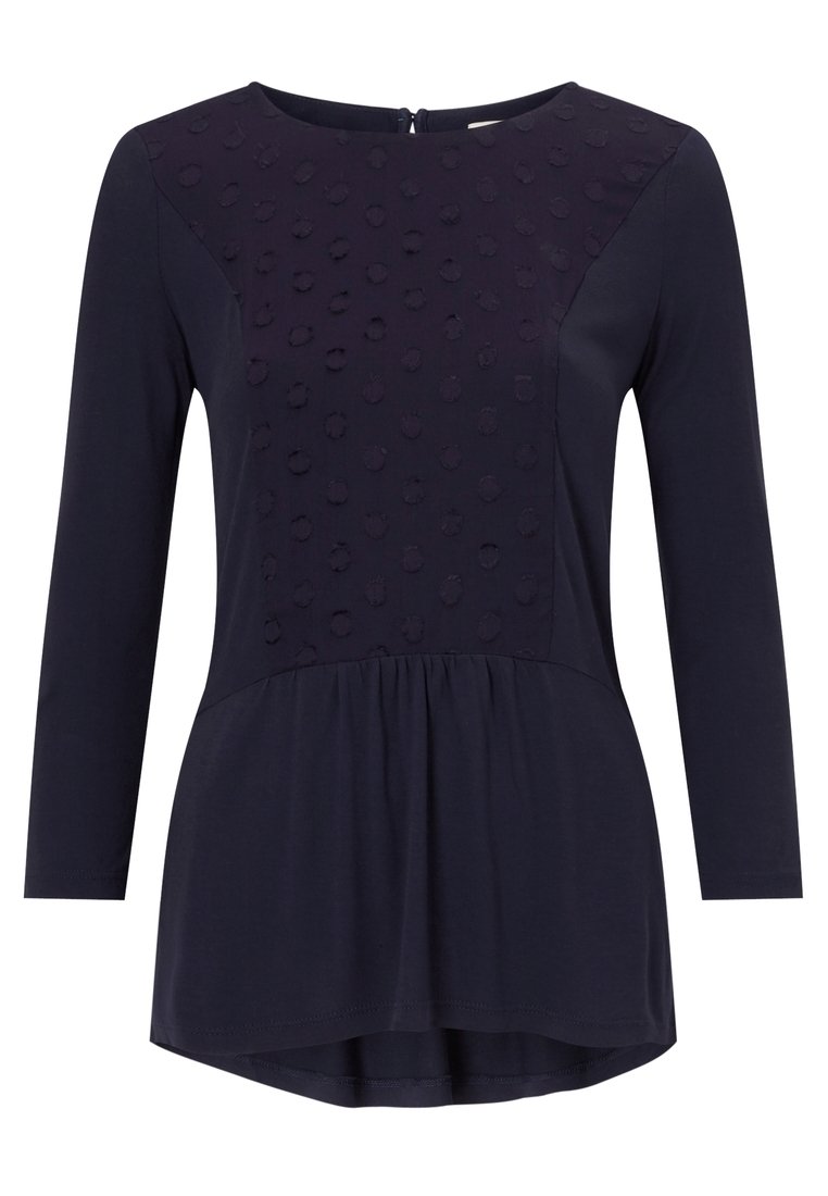 Mörkblå långärmad topp med texturerat prickmönster på övre panelen, lätt material, rund halsringning och peplum nederkant.