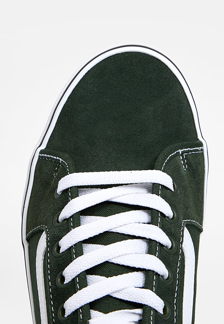 Baskets en suede vert avec des lacets blancs, bout rond et semelle blanche. Présente des coutures renforcées et des détails de rayures latérales.