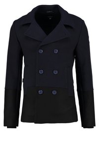 Abrigo de mezcla de lana en azul marino y negro con diseño de doble botonadura, botones grandes, solapas afiladas y mangas largas. Incluye bolsillos laterales.