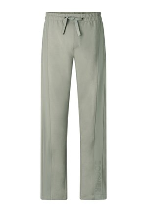 Světle zelené tepláky se stahovací šňůrkou a elastickým pasem a detailem s nápisem "BOGNER" poblíž dolní části pravé nohy.