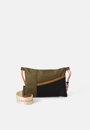 Olive green and black pouch bag with contrasting orange drawstrings. Features a textured surface, logo strap, and a diagonal zippered pocket.