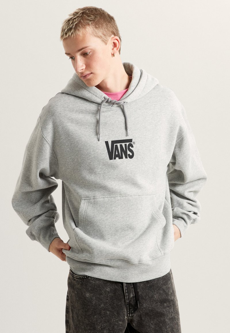 Sweat à capuche gris en mélange de coton, avec une poche frontale et le logo "Vans" en noir. Texture douce avec des poignets et un ourlet côtelés.