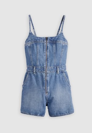 Mameluco sin mangas de mezclilla azul con tirantes ajustables, cremallera frontal, trabillas para cinturón y bolsillos laterales sobre un fondo gris claro.