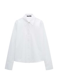 White long-sleeve shirt with a classic collar, button front, and subtle texture. Features a slightly cropped design and embroidered logo detail.