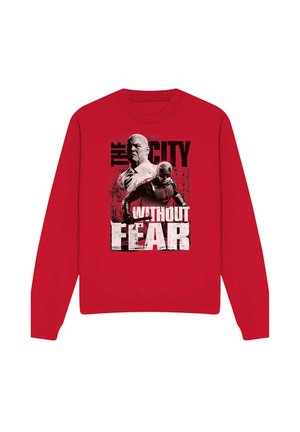 Red sweatshirt featuring two characters, one in a suit and the other in a superhero costume, with text "The City Without Fear."