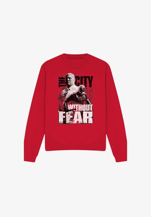 Red sweatshirt featuring two characters, one in a suit and the other in a superhero costume, with text "The City Without Fear."